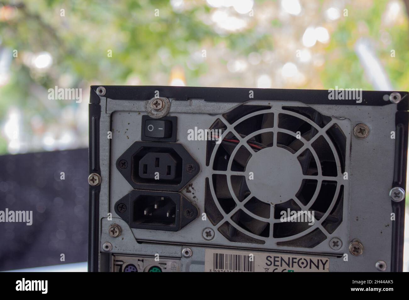 Pressing the on, off button on the power supply of a computer with a ...