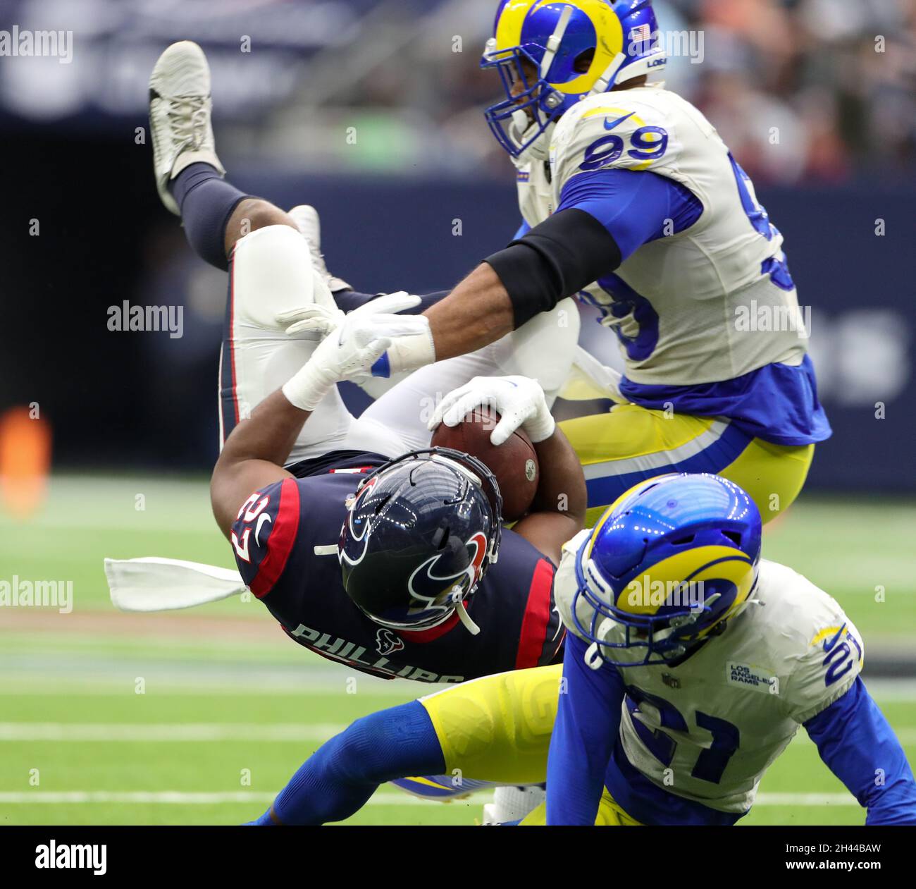 Houston, Texas, USA. October 31, 2021: Los Angeles Rams defensive tackle Aaron Donald (99) and cornerback Dont'e Deayon (21) bring down Houston Texans running back Scottie Phillips (27) during an NFL game between Houston and the Los Angeles Rams on October 31, 2021 in Houston, Texas. (Credit Image: © Scott Coleman/ZUMA Press Wire) Stock Photo