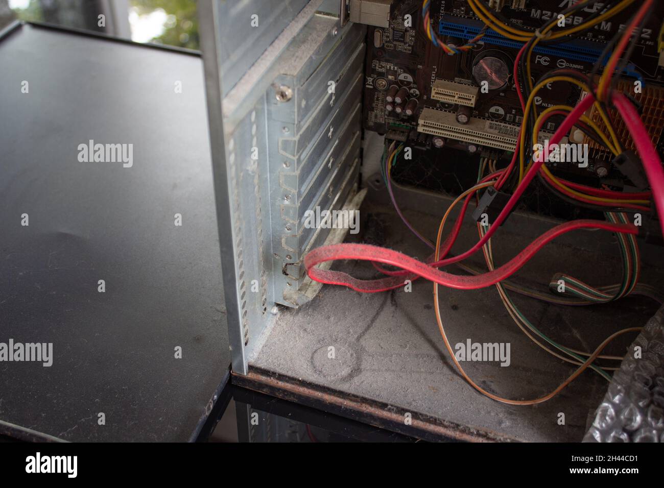 An old family computer filled with spider webs, dust and viruses. Maintenance is a key to keep computers healthy and working. Stock Photo