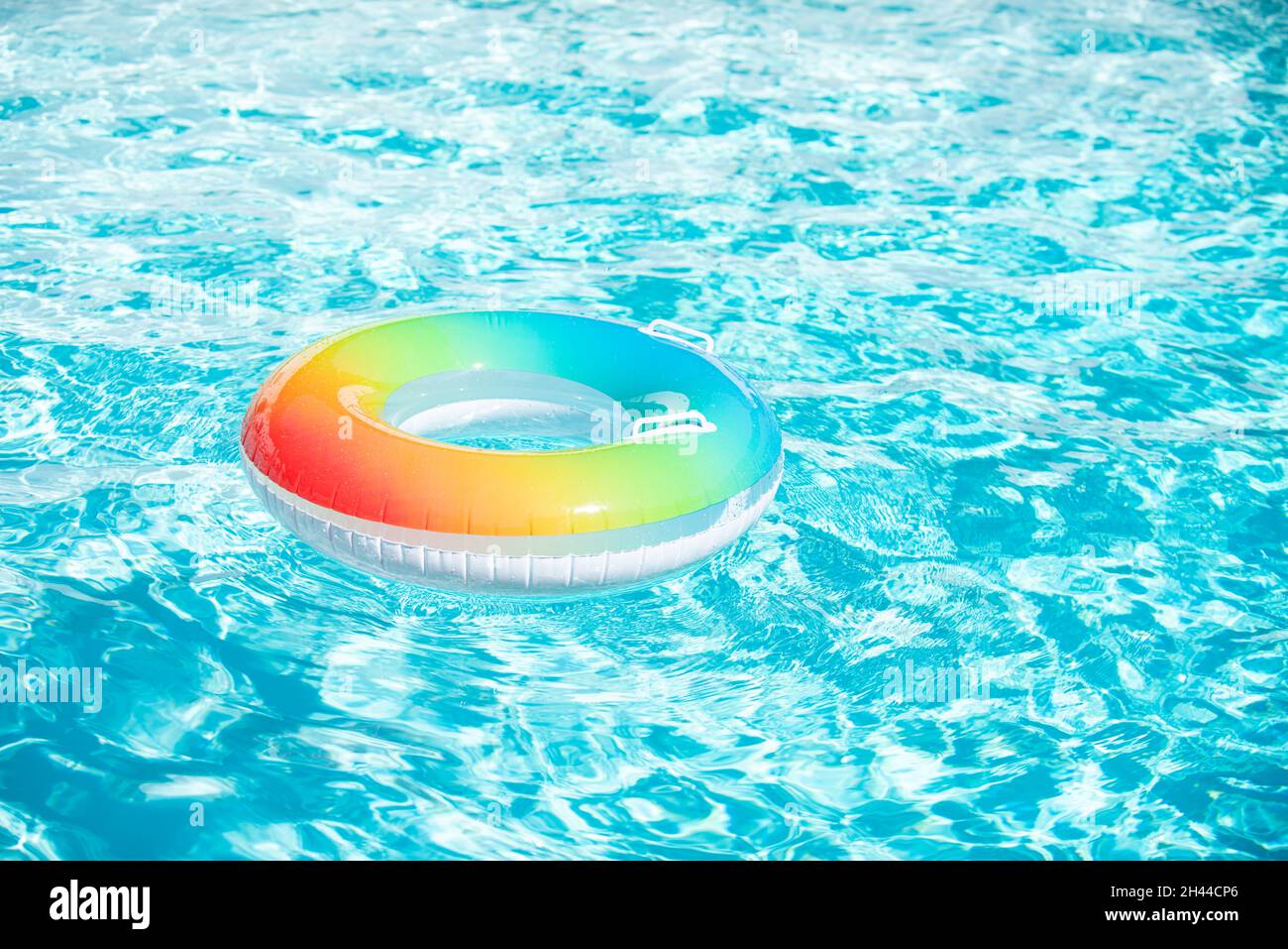 Pool float, floating in a blue swimming pool. Summer background Stock