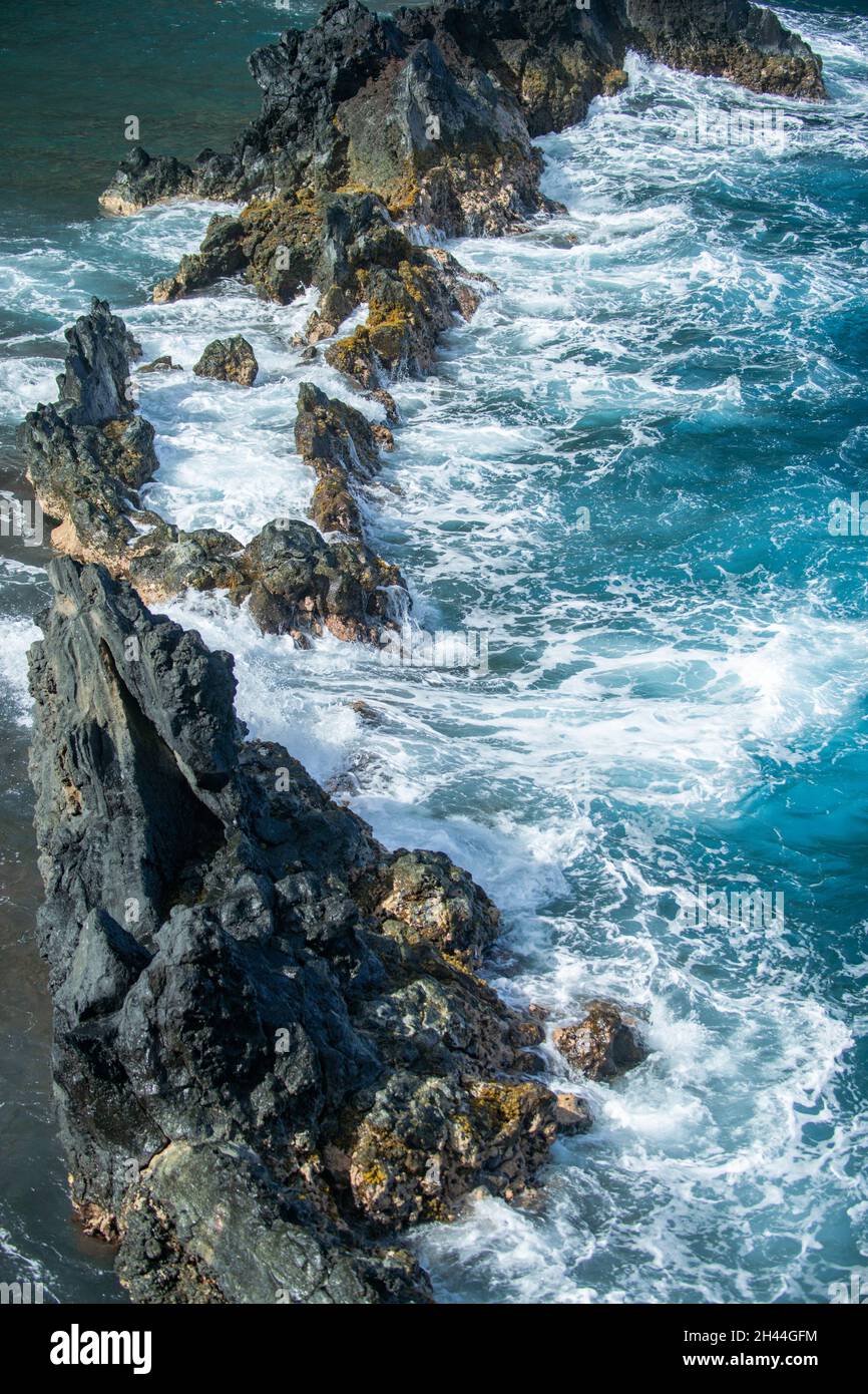 View of sea beach with waves and rocky coast Stock Photo - Alamy