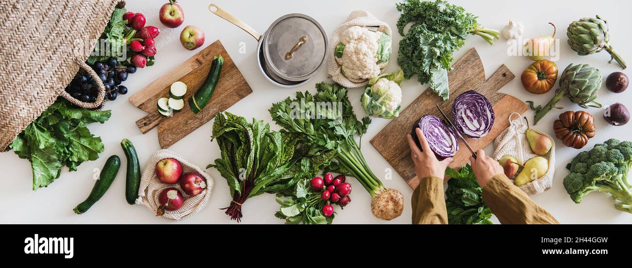 Female hands cutting red cabbage cooking with fresh veggies Stock Photo