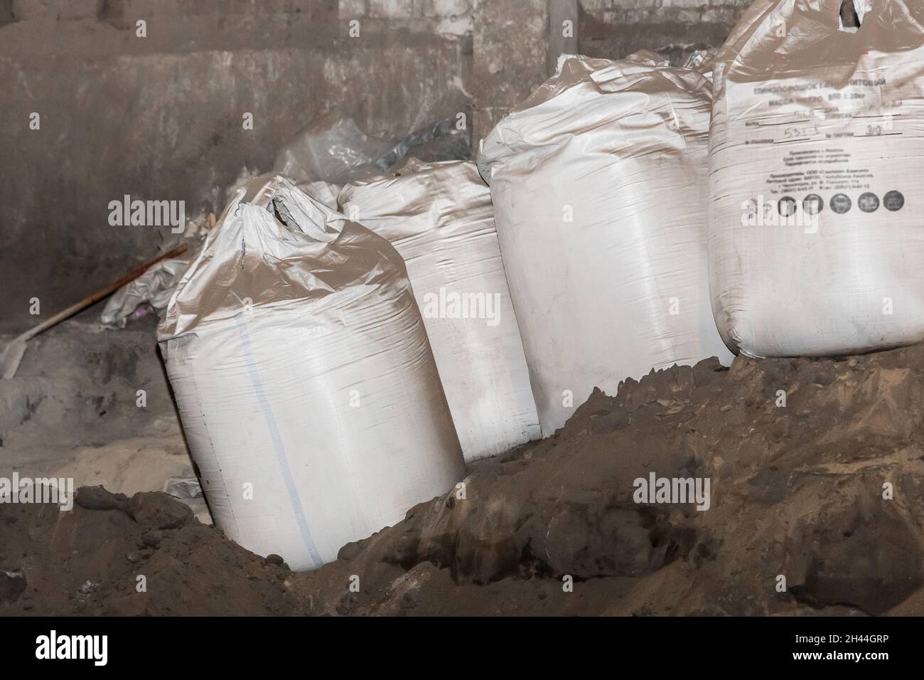Bentonite clay powder packed in bags at an industrial plant for processing sand, soil and land. Stock Photo