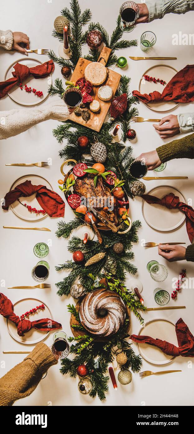 Flat-lay of Peoples hands with wine in glasses celebrating Christmas Stock Photo