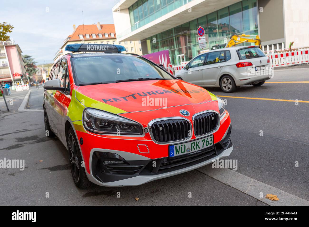 WUERZBURG, GERMANY - OCTOBER 31, 2021: A german Ambulance car from bavarian red cross stands near a street. Stock Photo