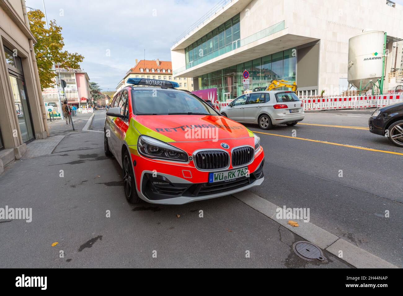 WUERZBURG, GERMANY - OCTOBER 31, 2021: A german Ambulance car from bavarian red cross stands near a street. Stock Photo