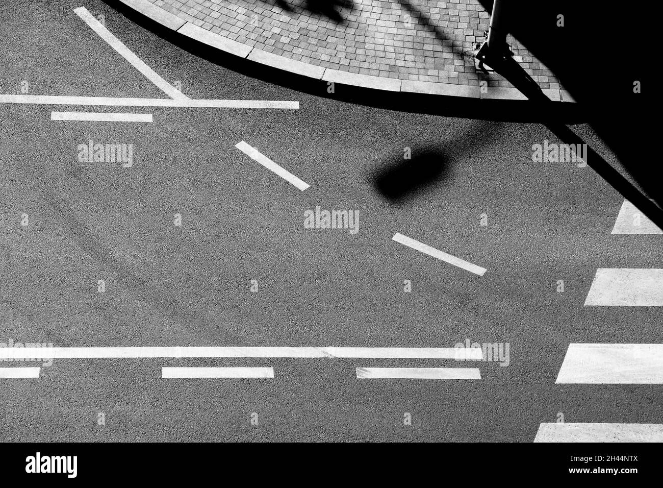 Shadows and road markings on city street in black and white, from above Stock Photo