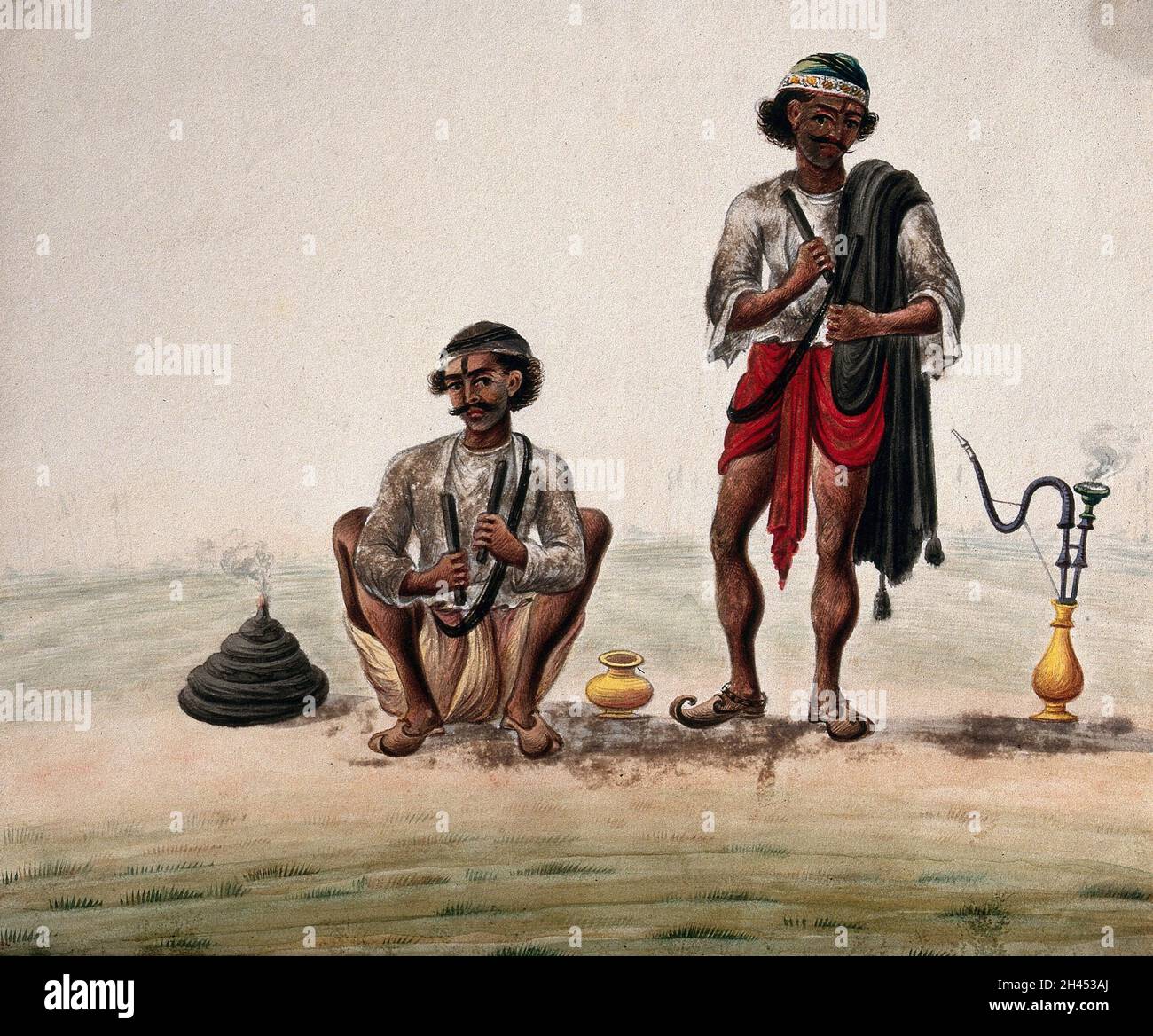 Two village men preparing to smoke a hookah. Gouache painting by an Indian painter Stock Photo