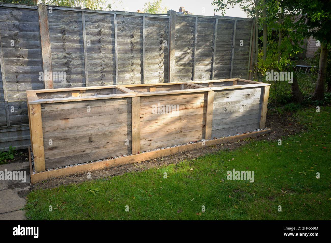 Empty timber tall deep root vegetable box planter ready for filling