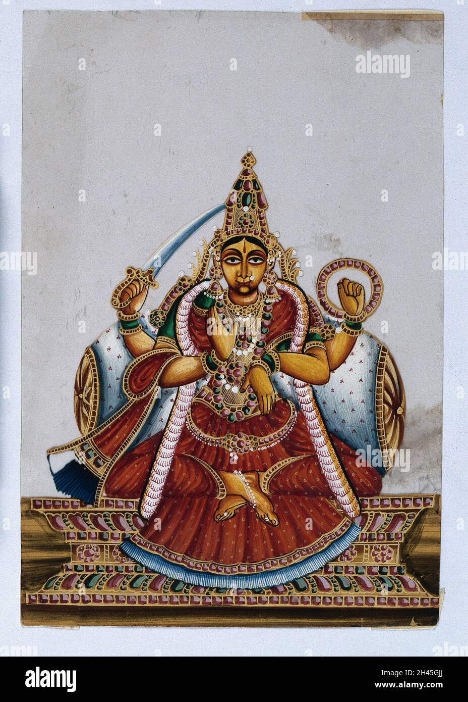 A four armed Indian goddess with her lower right hand raised in a