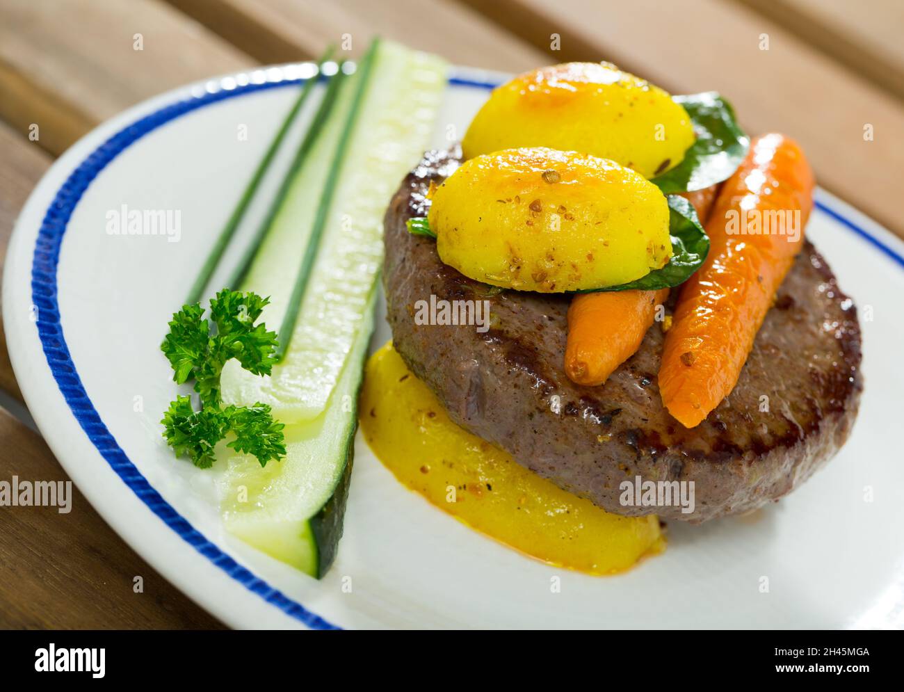 Beef rissole with new potatoes and carrot Stock Photo - Alamy