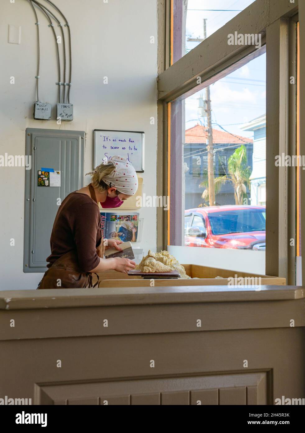 NEW ORLEANS, LA, USA - OCTOBER 29, 2021: Baker cutting dough to make pie crust at Windowsill Pies on Freret Street Stock Photo