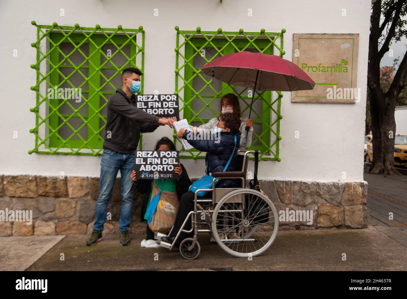 A group of people protests outside Profamilia, family planification health center in Bogota against the practice of abortions in Colombia with a sign that reads 'Pray for abortions to end' on October 30, 2021. Stock Photo