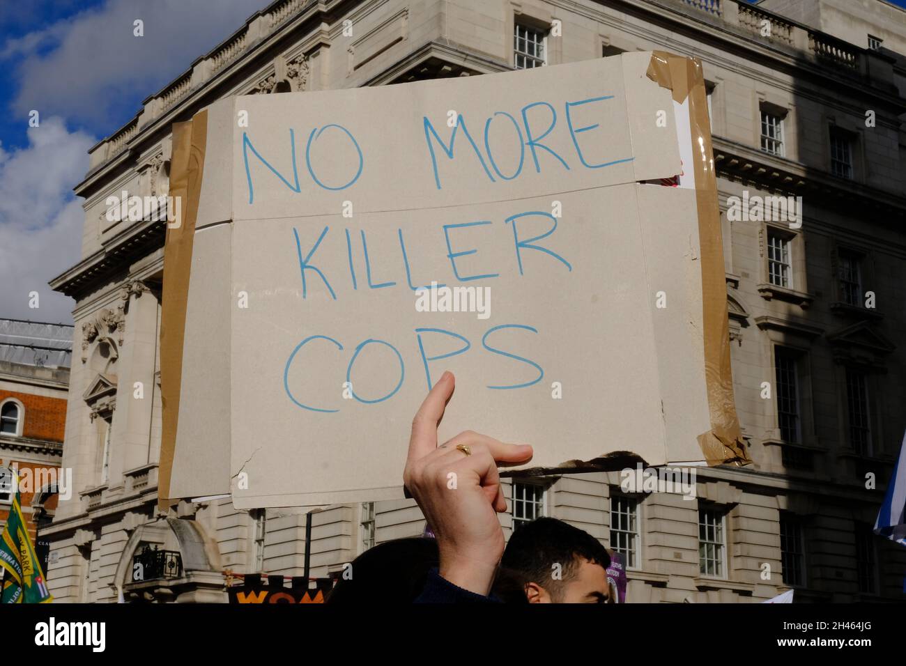 London, UK. A protester attending the annual United Friends & Family Campaign memorial march holds up a placard with the words 'No More Killer Cops' Stock Photo