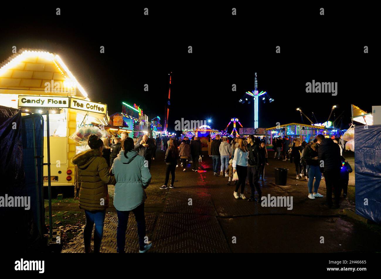 People at the night time autumn fair in the park Stock Photo