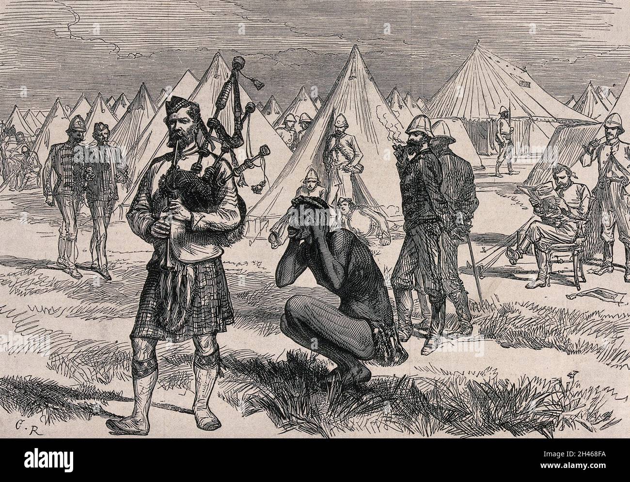 A member of the Royal Scots Fusiliers playing the bagpipes in a camp in