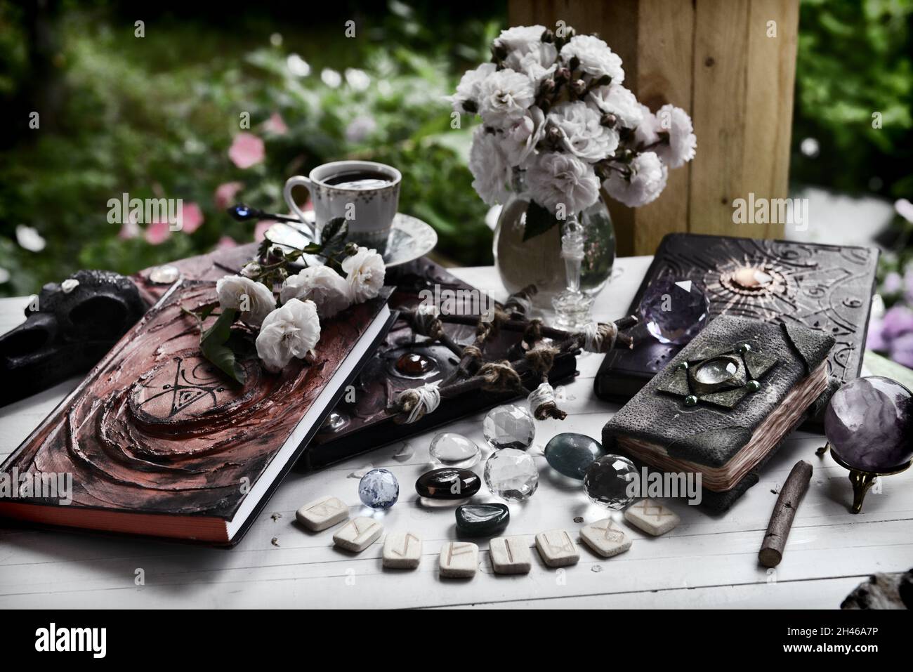 Grunge still life with old book of spells, runes amd witch magic objects on ritual table.  Esoteric, occult and mystic concept for witchcraft Stock Photo