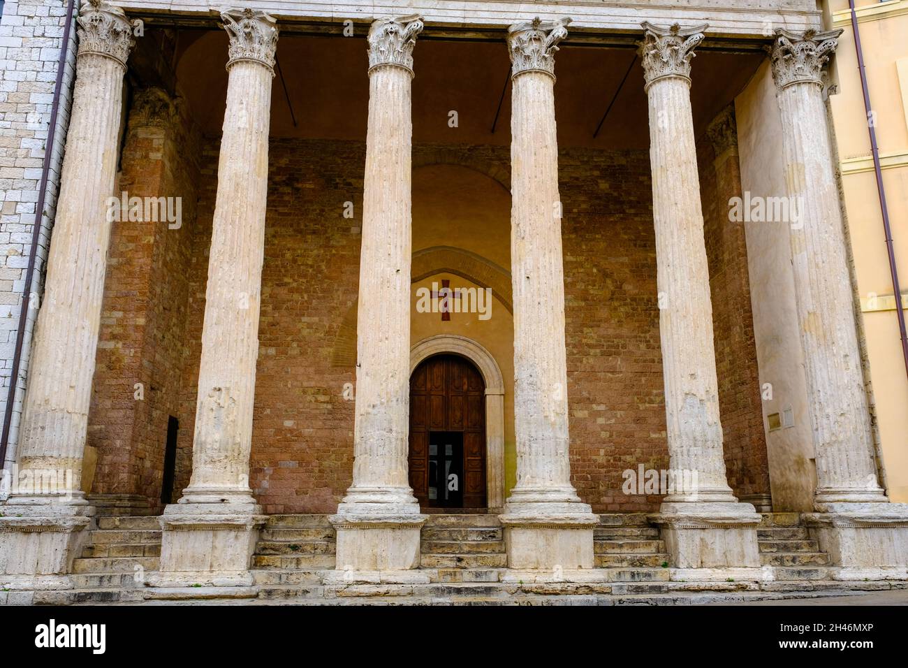 Corinthian columns standing at the entrance of Santa Maria sopra Minerva also known as the Temple of Minerva in Assisi Italy Stock Photo