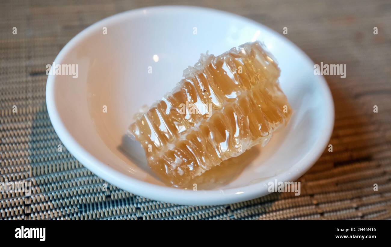 Honeycombs Unprocessed Unpasteurized Original Raw Honey in Bowl as it Exists in the Beehive Stock Photo