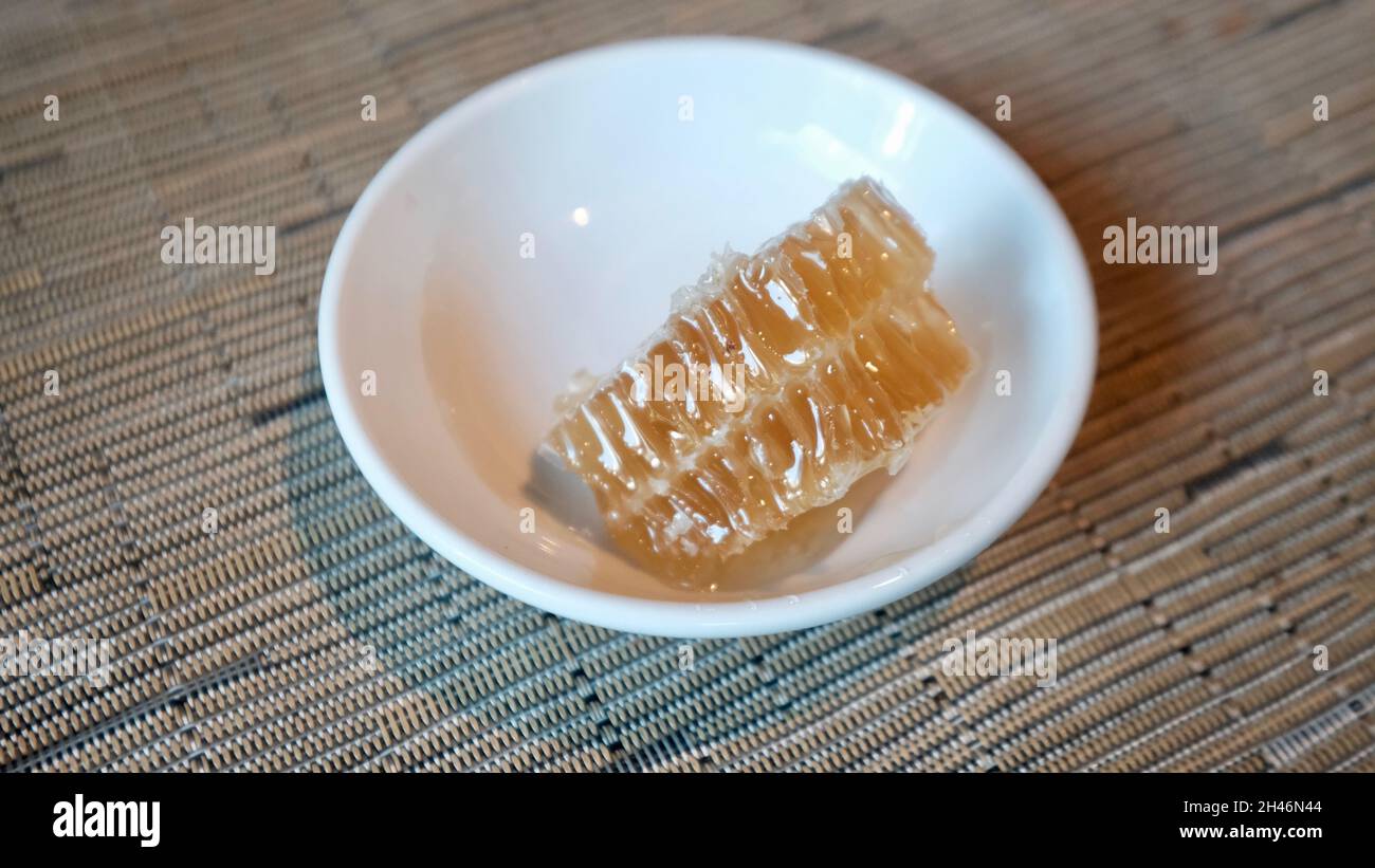Honeycombs Unprocessed Unpasteurized Original Raw Honey in Bowl as it Exists in the Beehive Stock Photo