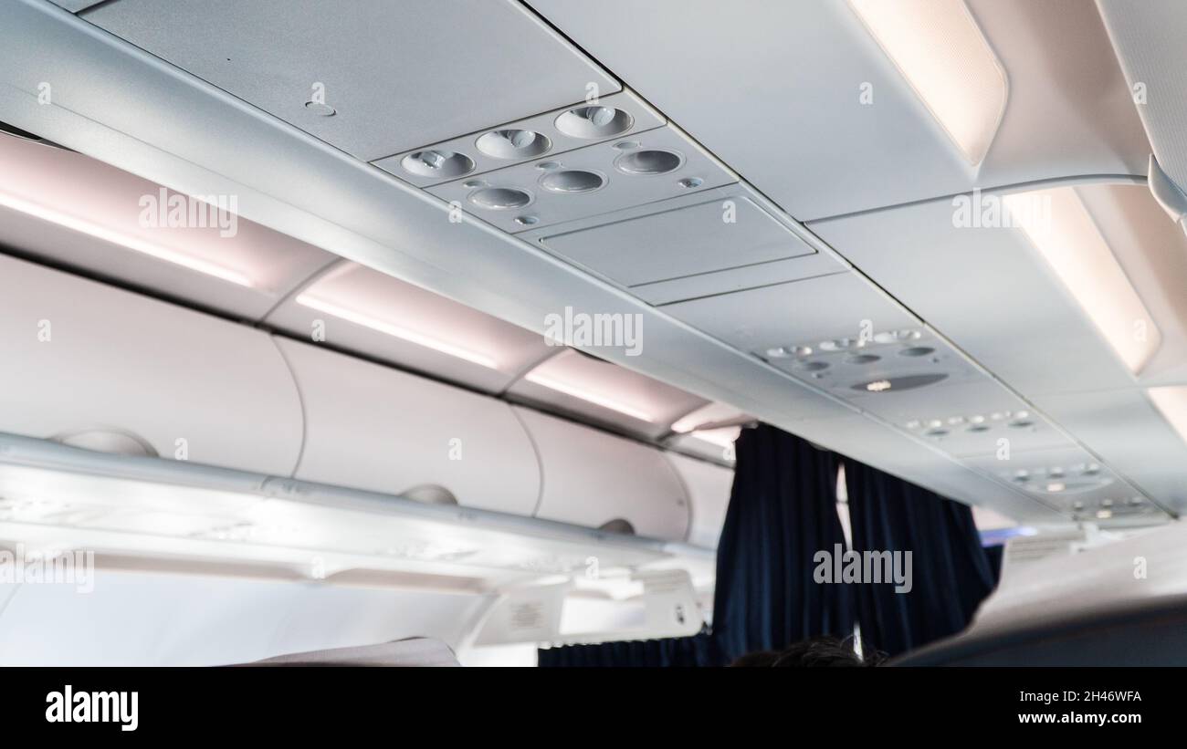 Ceiling of the airplane with luggage compartment. Aircraft interior