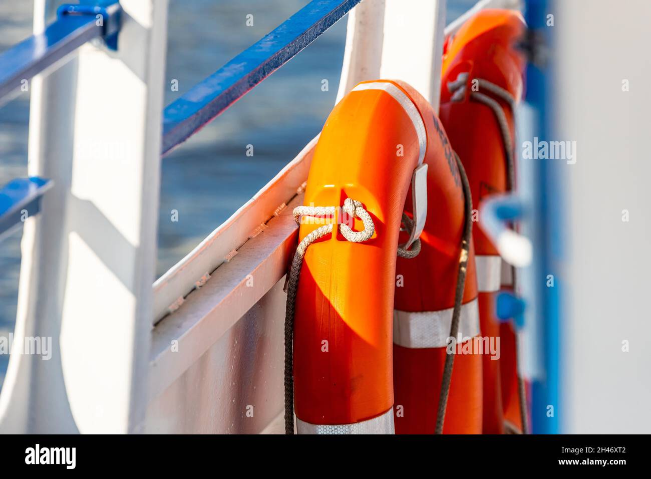close-up lifebuoy on a boat. Red lifebuoy on ship railing with sea ...