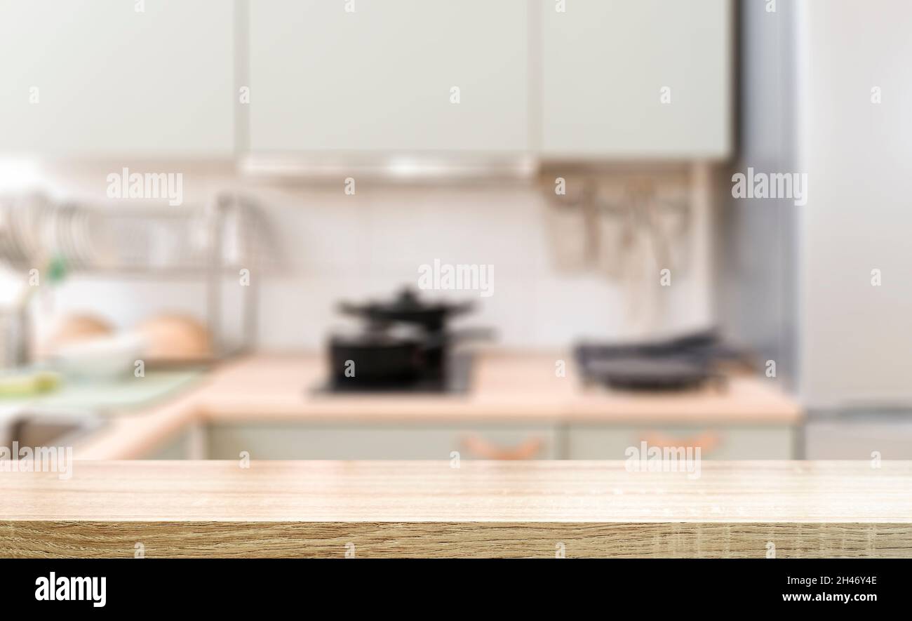 Kitchen table background. Wooden table in the interior of a home kitchen during the day. Food, cooking, groceries mockup. High quality photo Stock Photo