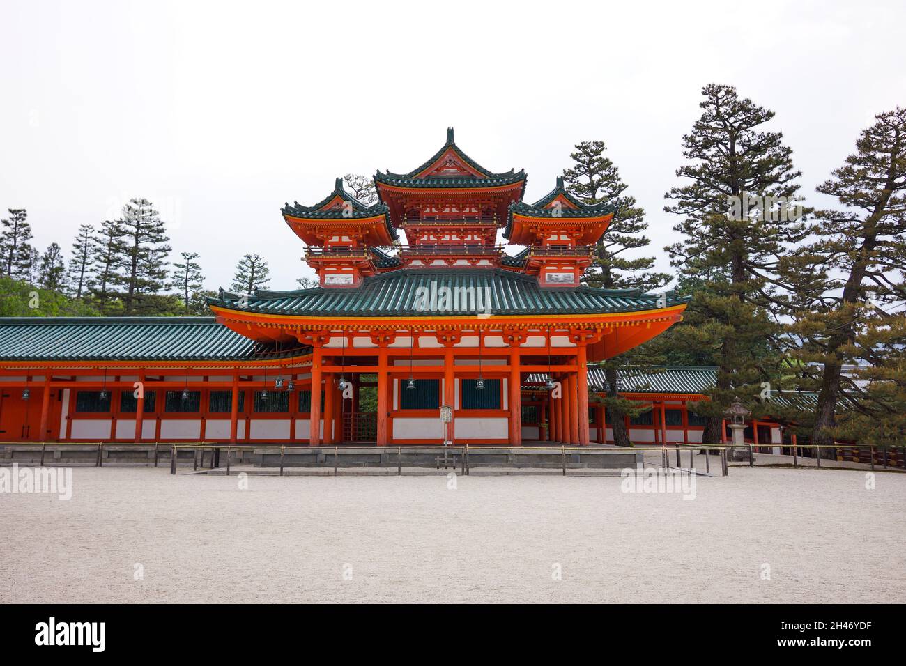 View of Souryu-rou Tower in the inner courtyard of Heian Shrine with trees and bright sky background. No people. Stock Photo