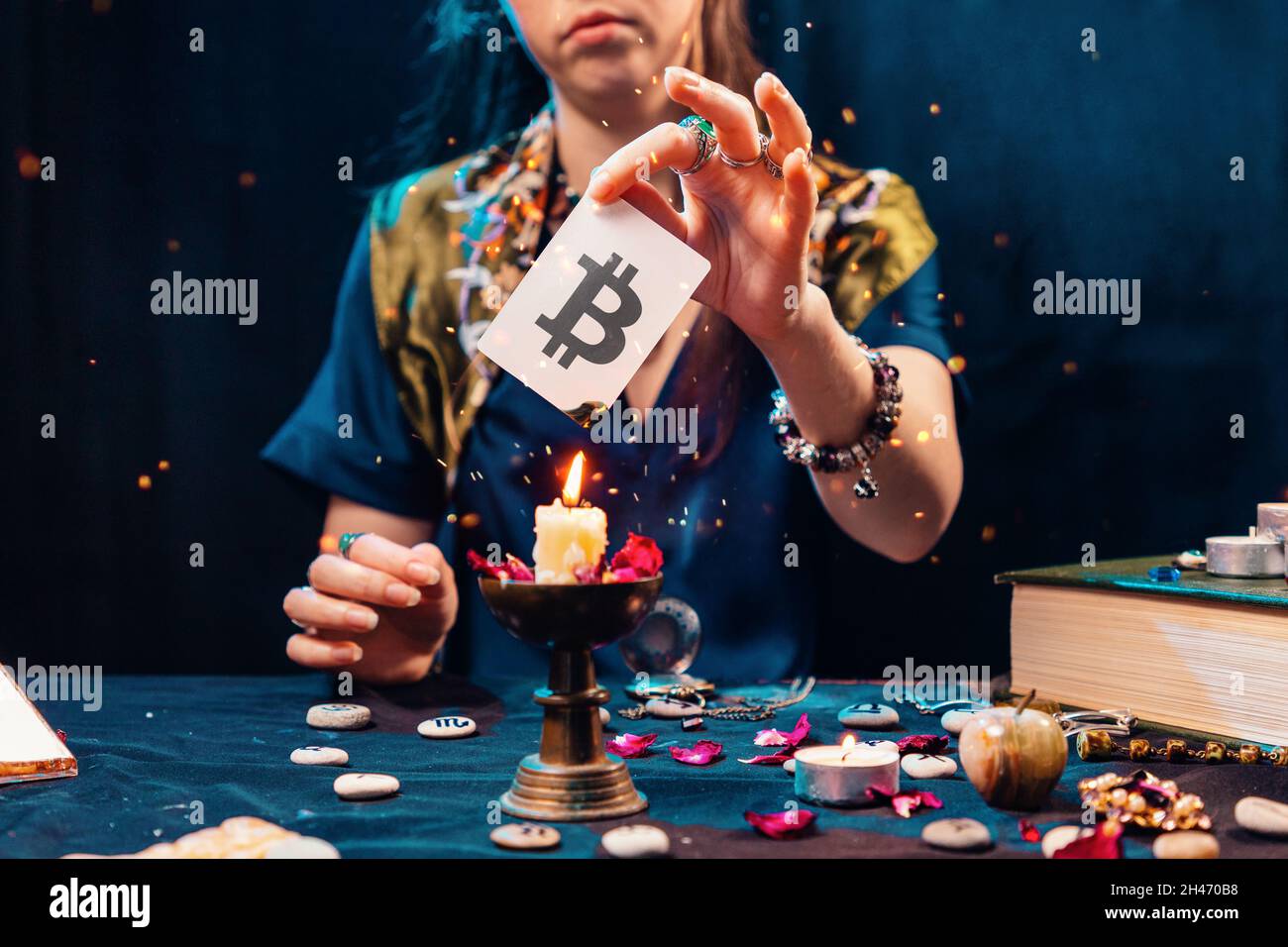 The fortune teller shows a card with the bitcoin currency, and sets it on  fire from the candle flame. The concept of unpredictable Cryptocurrency  Exch Stock Photo - Alamy