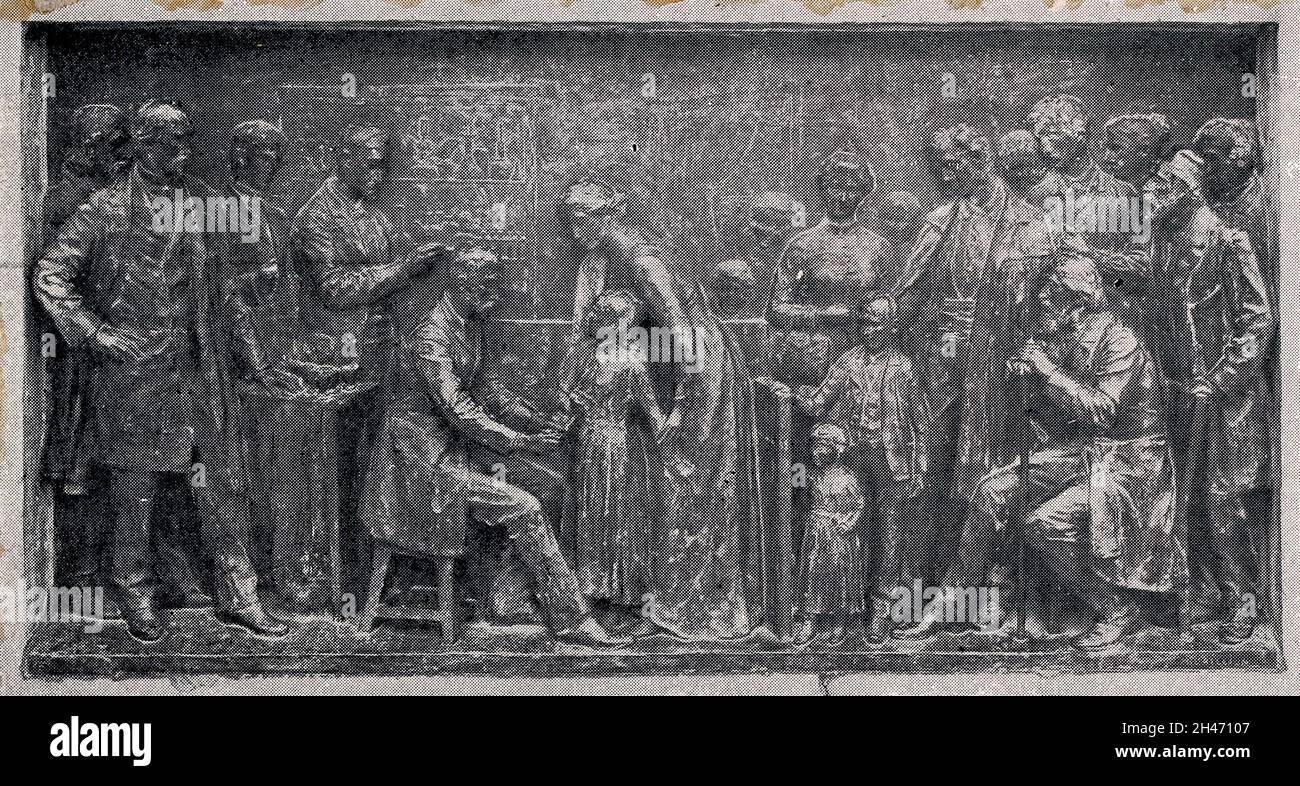 Louis Pasteur supervising the inoculation of a child against rabies. Process print after a bronze relief at the Pasteur Institute, Paris. Stock Photo