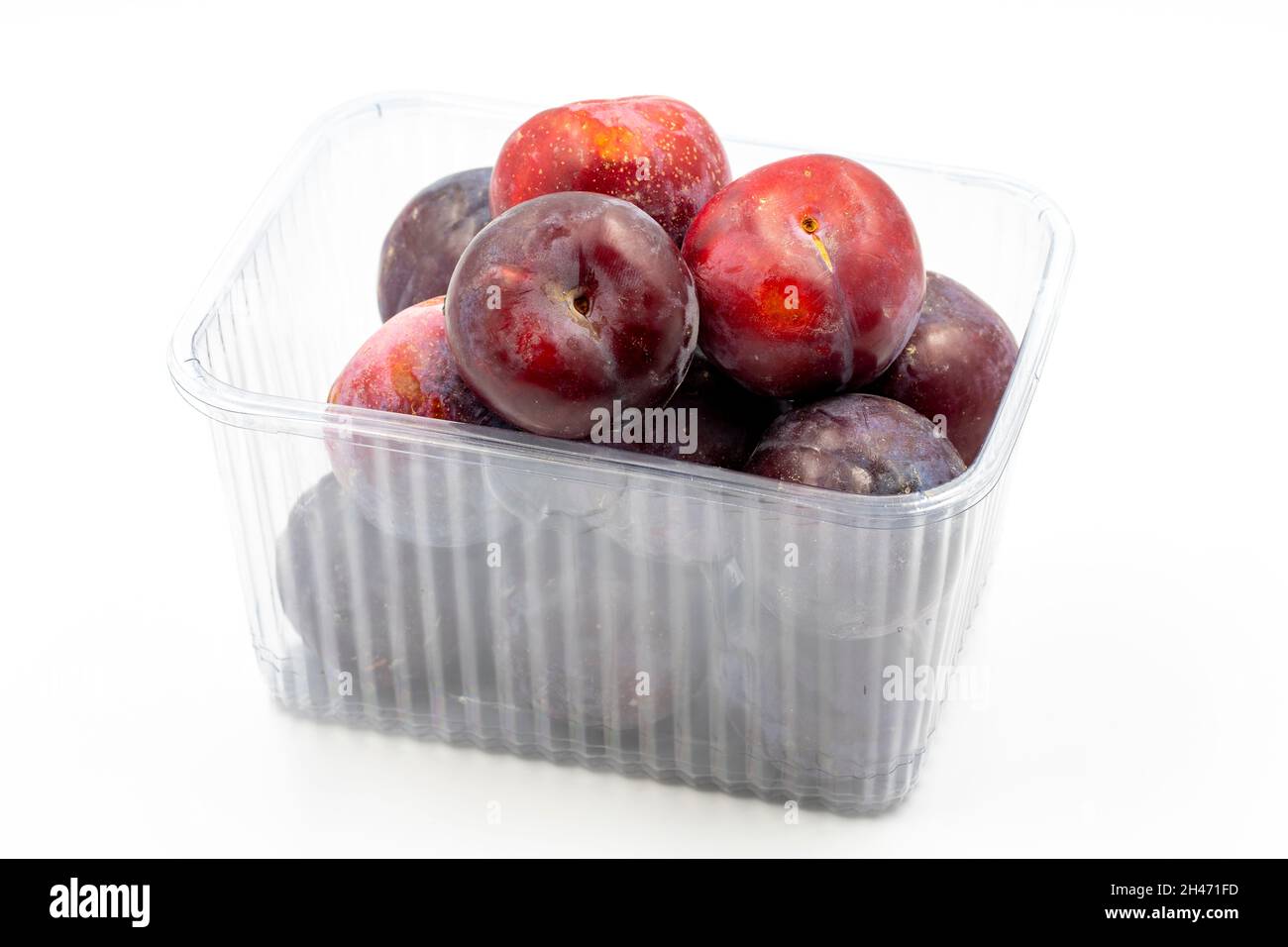 Packed black plum on a white background. Combined with a mature black plum shade. close up Stock Photo