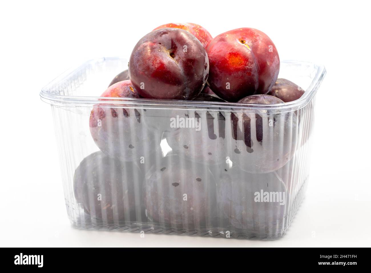 Packed black plum on a white background. Combined with a mature black plum shade. close up Stock Photo