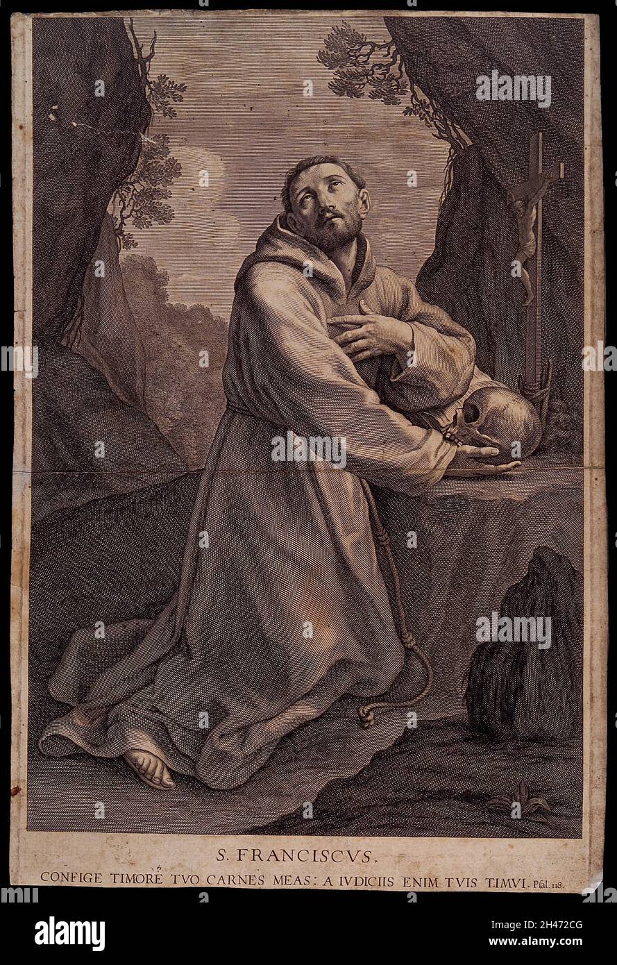 Saint Francis of Assisi in the wilderness, holding a skull, kneeling in