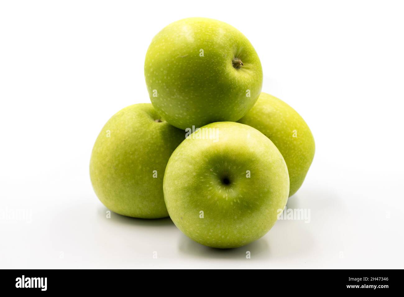 Sour apples on a white background. Ripe Green combined with a shade of sour apple. close up Stock Photo