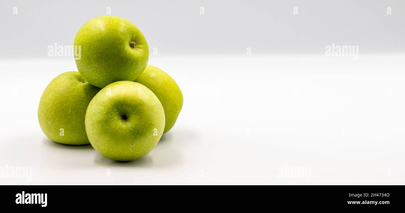 Sour apples on a white background. Ripe Green combined with a shade of sour apple. Empty space for text. copy space Stock Photo