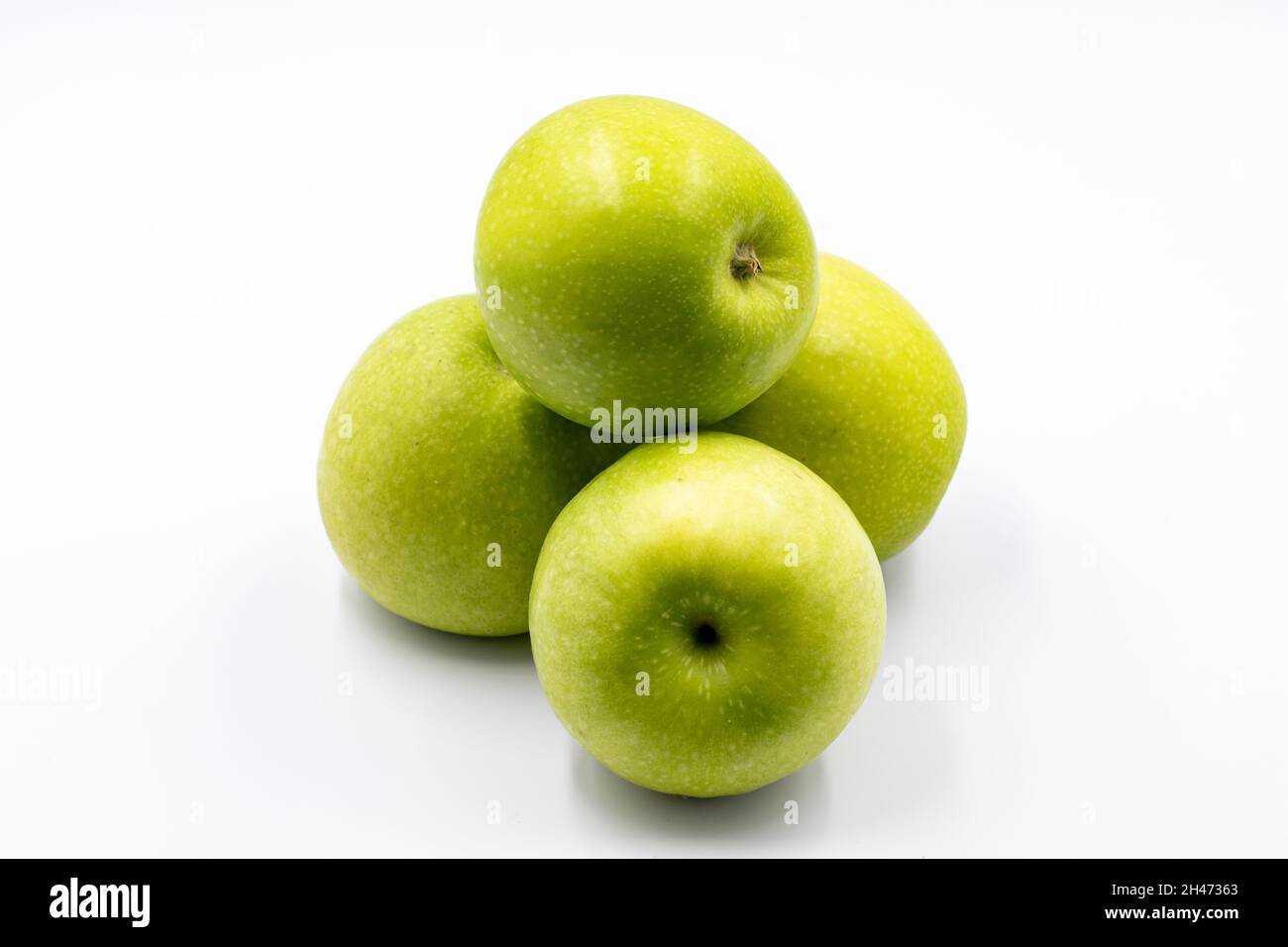 Sour apples on a white background. Ripe Green combined with a shade of sour apple. close up Stock Photo