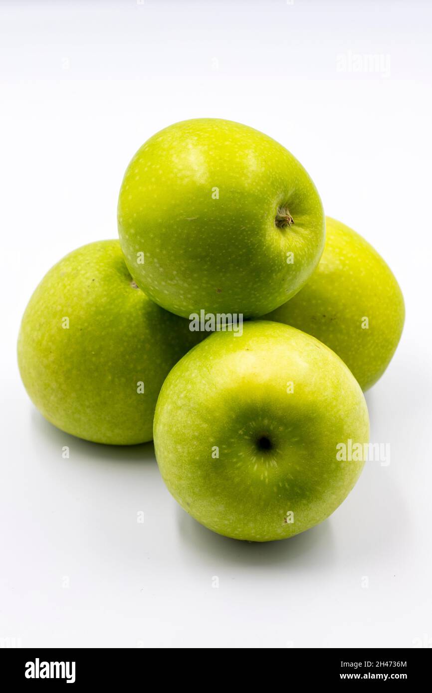 Sour apples on a white background. Ripe Green combined with a shade of sour apple. Story format close-up Stock Photo