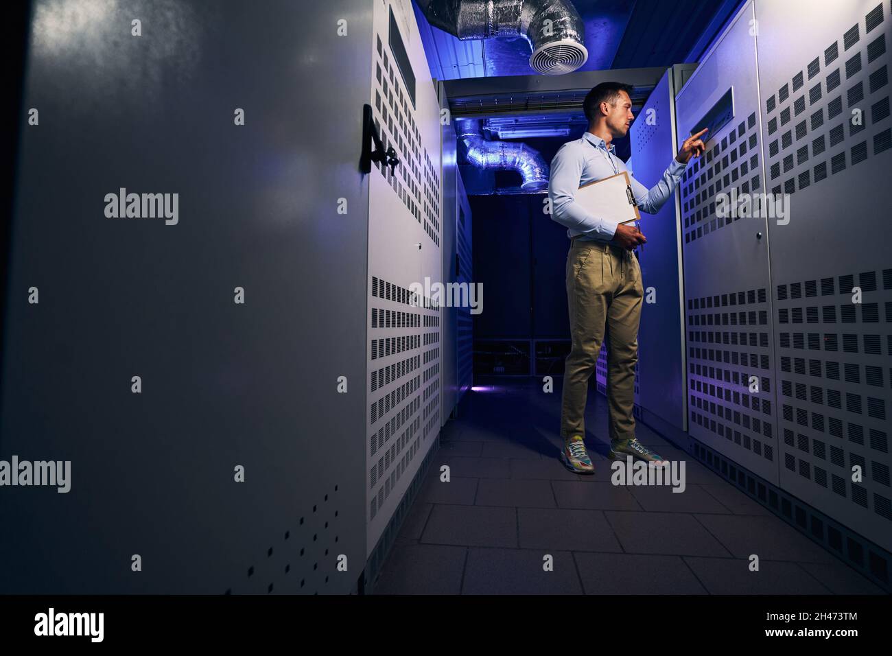 Experienced technician performing visual inspection of server hardware