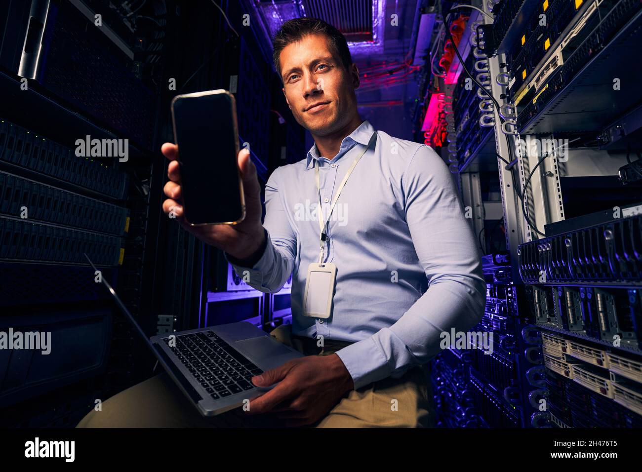 Caucasian IT technician working in server room Stock Photo