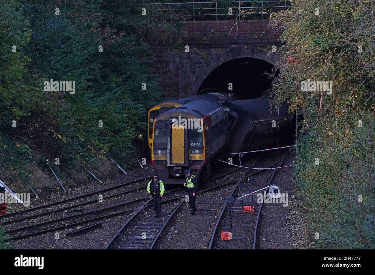 Police officers at the scene of a crash involving two trains near the