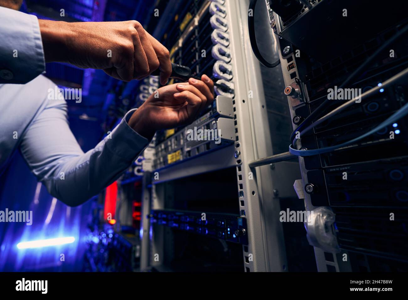 Experienced IT technician installing new network equipment Stock Photo