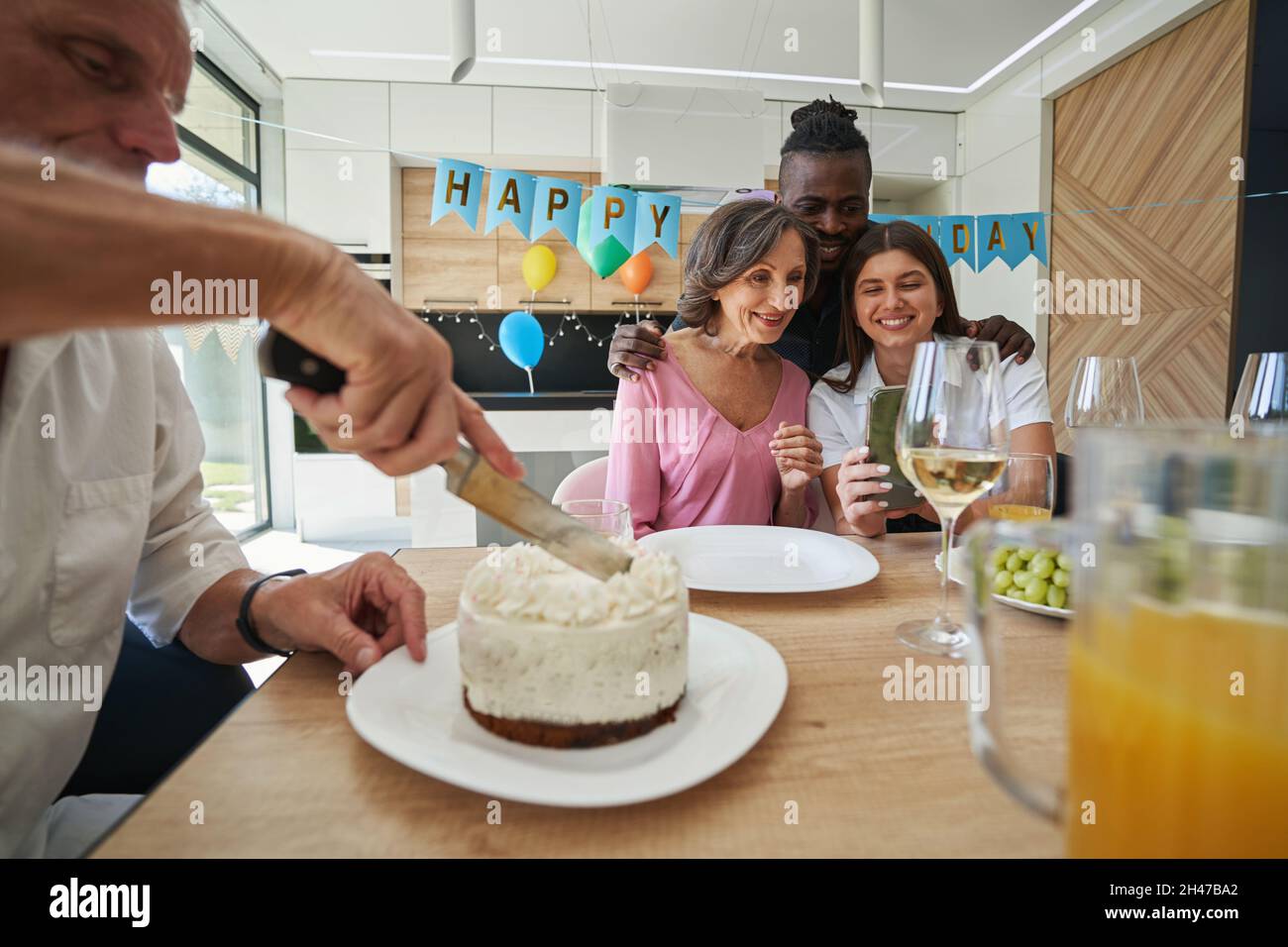 Man is cutting cake for birthday dinner Stock Photo