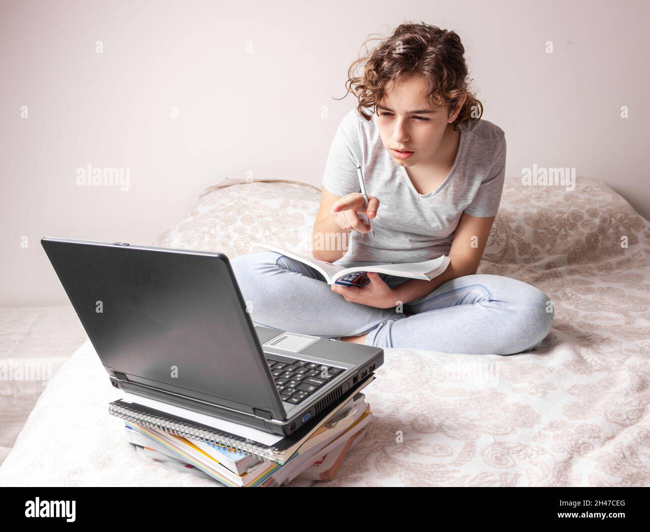 Teenager girl studying online at home. School girl with the lap top on