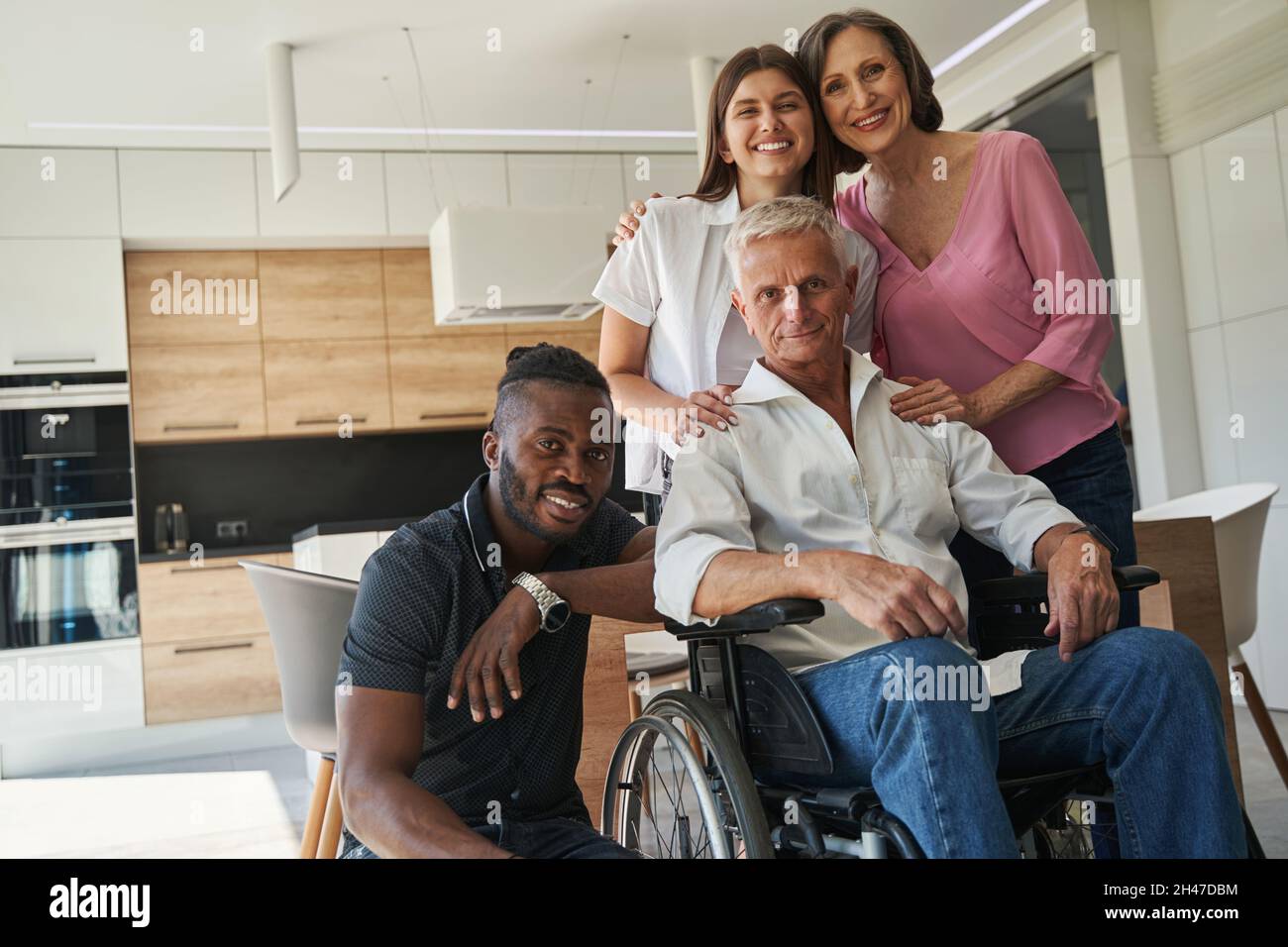 Relatives are supporting man with physical disability Stock Photo
