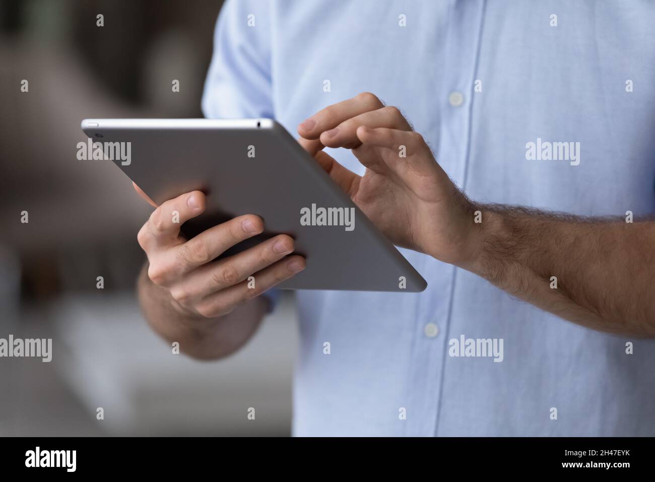 Close up young man using digital computer tablet applications. Stock Photo