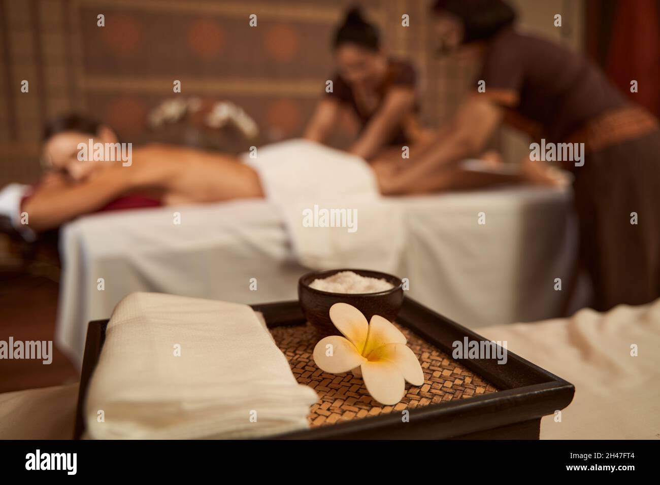 Female client getting fourhand massage in wellness center Stock Photo Alamy