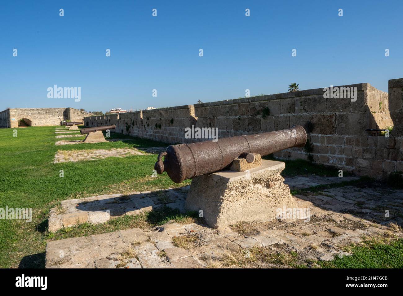 Ancient, rusty Cannons on the fortified walls of the old City of Acre Israel, protecting the port and city from naval invasion. Now a historic esplana Stock Photo