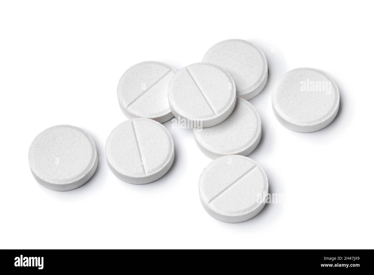 Heap of medical white tablets close up isolated on white background Stock Photo