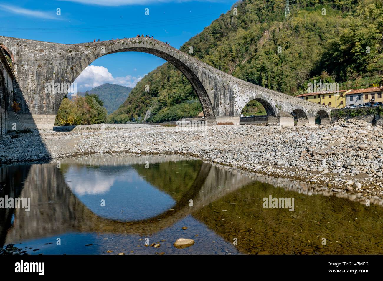 The famous ancient Ponte della Maddalena or del Diavolo is reflected in ...