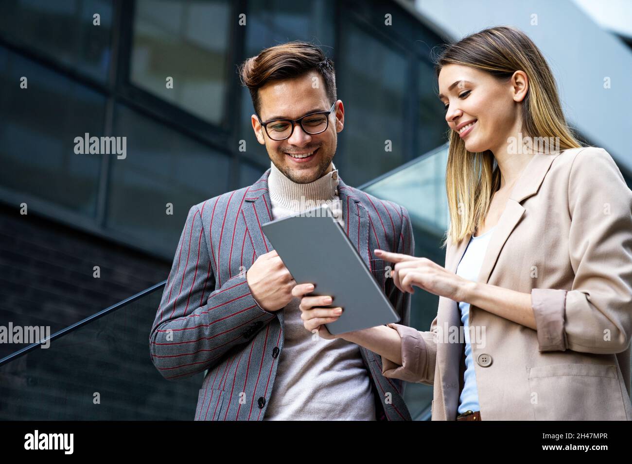 Portrait of successful business people working, talking together in urban background. Stock Photo